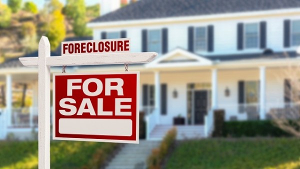 Foreclosure Home For Sale Sign in Front of Large House